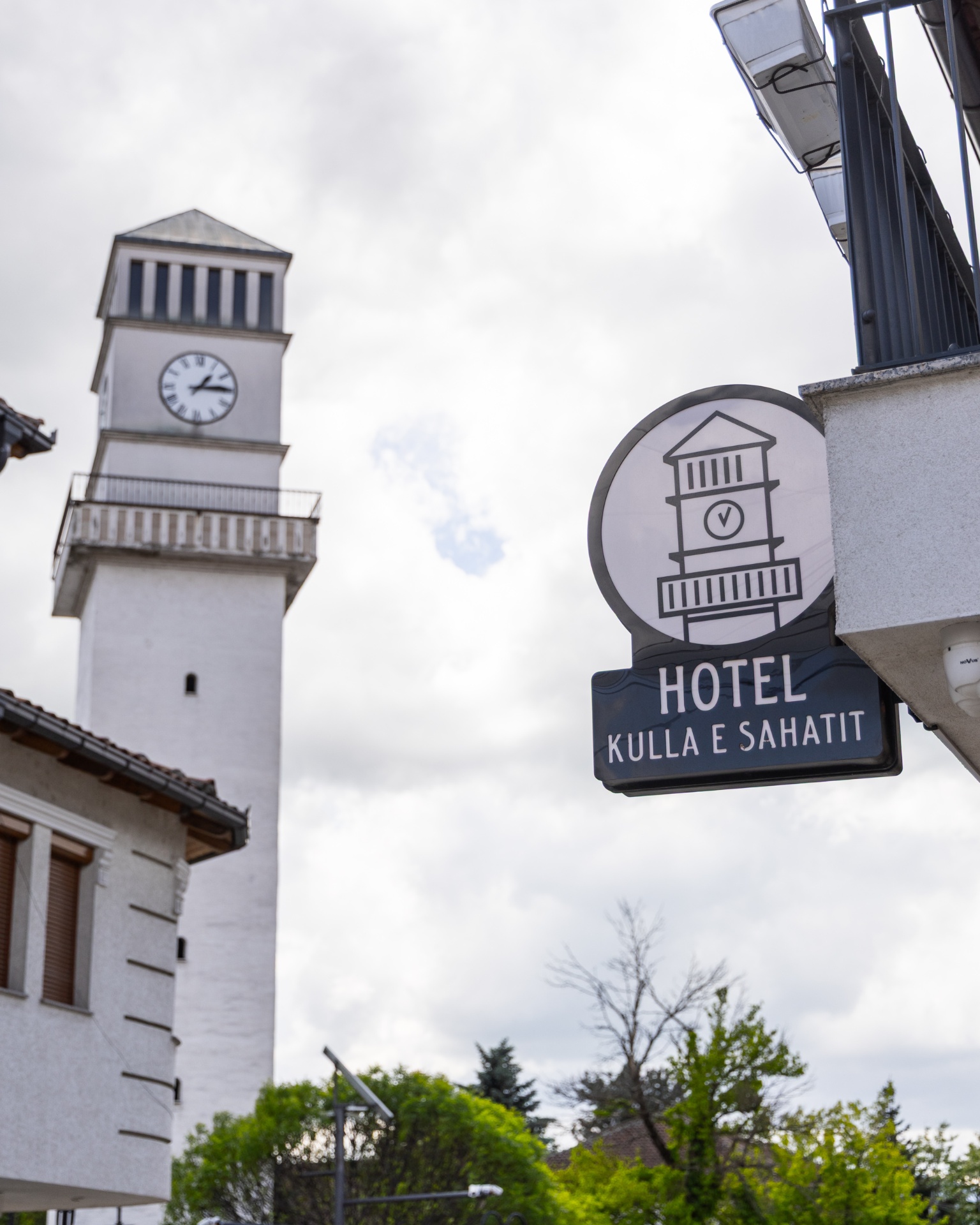 Hotel Kulla e Sahatit sign in front of the Clock Tower of Gjakova