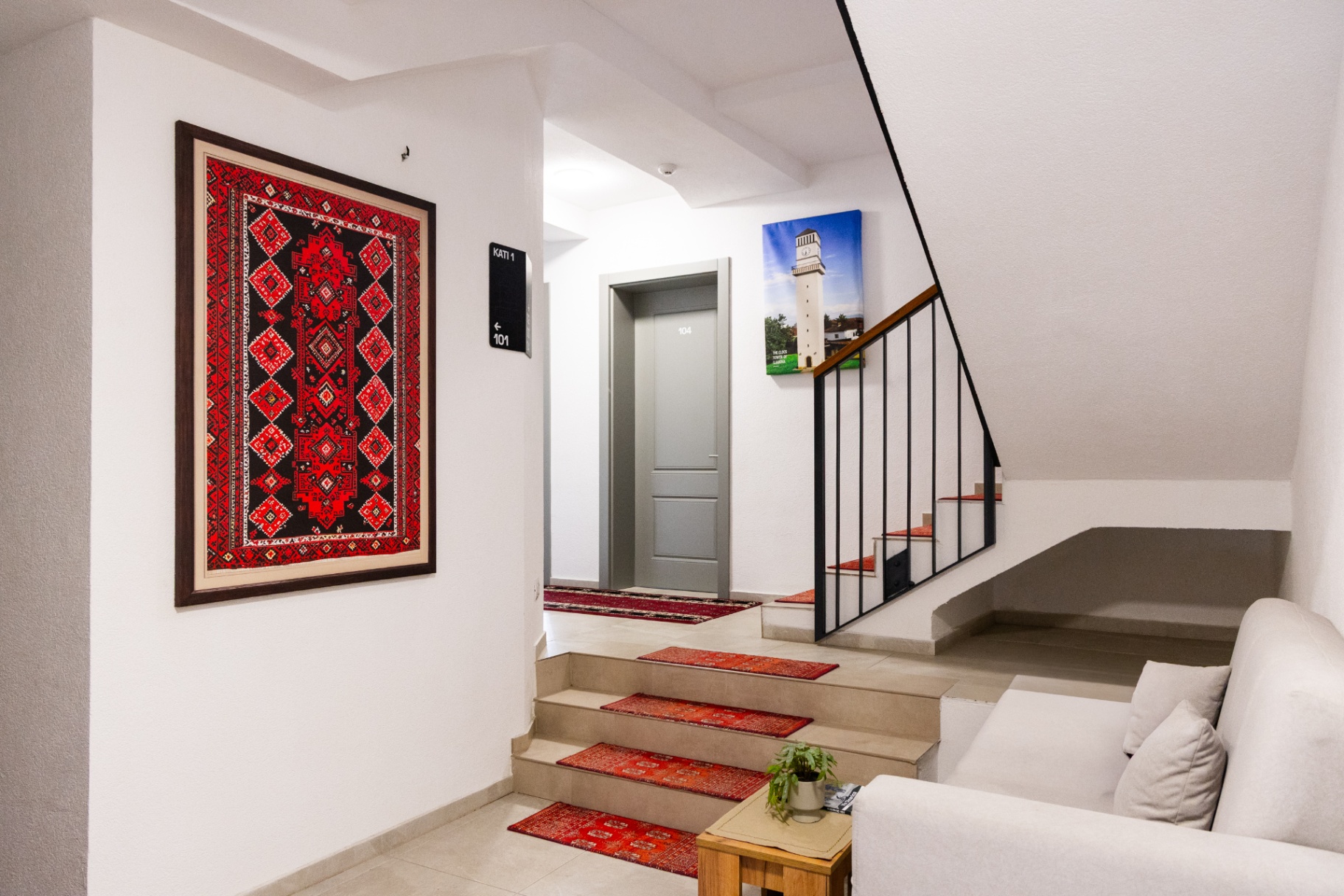 Interior stairwell with framed traditional Kosovar textile
